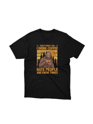 For the coffee lovers with a twist, Apparel by Cetakshop's 'Drink Coffee Hate People And Know Things' graphic tee, a bold statement on Black fabric. The image shows a coffee quote graphic tees.