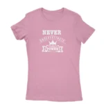 Image of a Azeala t-shirt with a white text graphic that reads 'NEVER UNDERESTIMATE THE POWER' with a crown symbol above the text, promoting a message of empowerment and resilience.