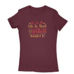 Image of a Maroon 'Life is Short, Your Lashes Shouldn't Be' T-shirt for women, by Apparel by Cetakshop, featuring playful typography and lash illustrations for beauty enthusiasts.