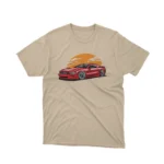 A Sand tee with a classic car under a sunset design, from Apparel by Cetakshop, for vintage car lovers.