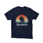A Navy tee with a 'Bassquatch' playing the guitar, from Apparel by Cetakshop, for those who believe in the beat.