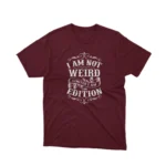 A Maroon tee that reads 'I Am Not Weird I Am Limited Edition', celebrating individuality, from Apparel by Cetakshop.