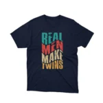 A playful 'Real Men Make Twins' slogan on a navy graphic tee from Apparel by Cetakshop, ideal for dads with a sense of humor.