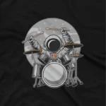 close up image of An astronaut playing drums on a black graphic tee, from Apparel by Cetakshop, merging music with the cosmos. The image shows a astronaut drummer graphic tees.