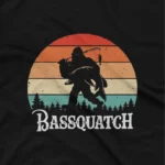 close up image of A Black t-shirt with a graphic of a bigfoot holding a fishing rod from Apparel by Cetakshop. The image shows a bassquatch fishing graphic tees.