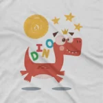close up image of Playful Dino Tee by Apparel by Cetakshop. Kids t-shirt with 'dinosaur, stars, and moon graphic' on white fabric.
