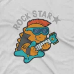 close up image of Rock Star Dino Tee by Apparel by Cetakshop. White kids t-shirt featuring a guitar-playing dinosaur with 'Rock Star' text.