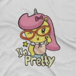 close up image of Pretty Unicorn Tee by Apparel by Cetakshop. Pink Unicorn Saying I'm Pretty kids t-shirt design from Apparel by Cetakshop on a white tee.